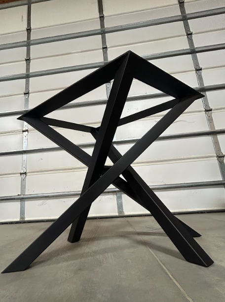 Finished steel table base in matte black, welds dressed smooth before coating.