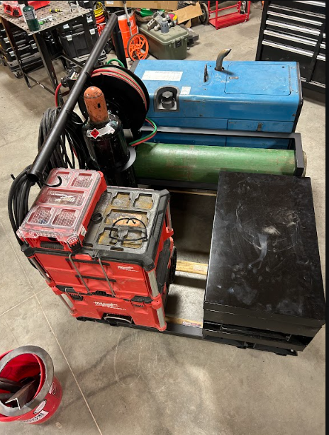 Cart of bottles, torch, leads and tool cases that travels with the truck.