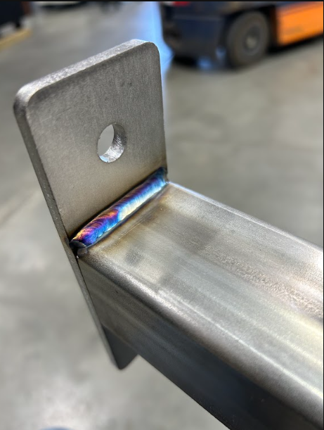TIG weld joining a drilled mounting tab to square tube