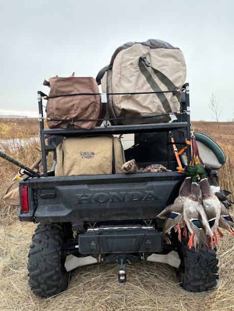 Tube cargo rack built for the bed of a side-by-side, out in the field in use.