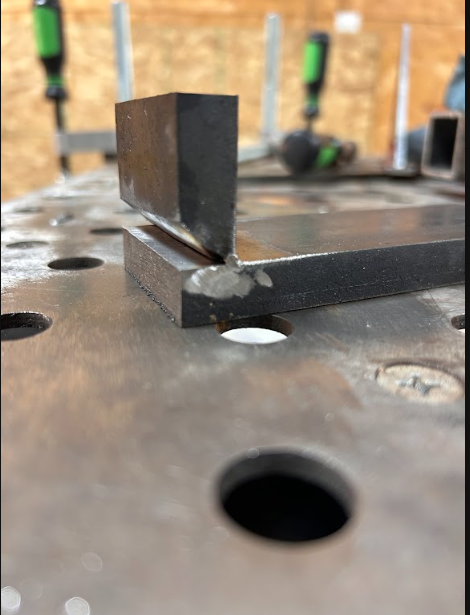 Joint fit-up and tack welding on the fixture table ahead of the final passes.