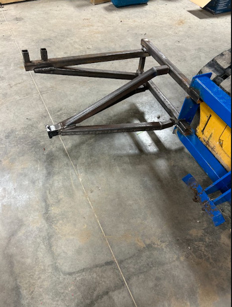 Welded lift arm frame built from square tube, ready to be fitted to the machine.