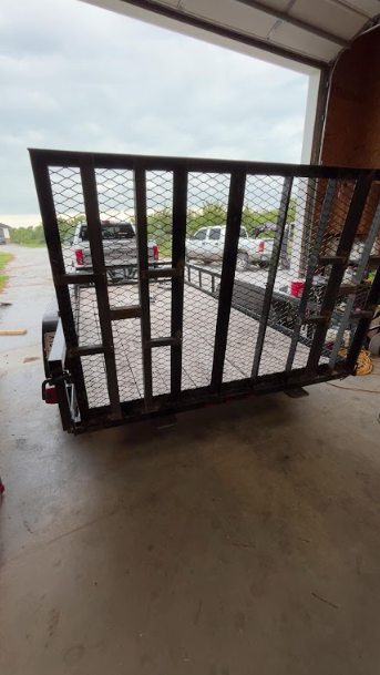 Mesh trailer ramp gate with its steel frame and hinges repaired and refitted.