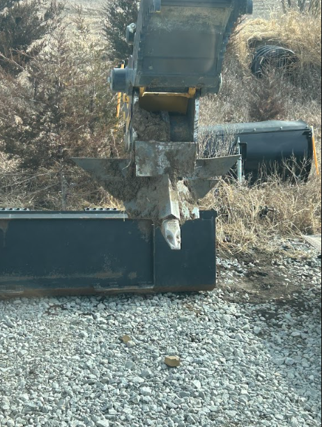 Cracked push frame on a box blade rewelded and reinforced out in the yard.