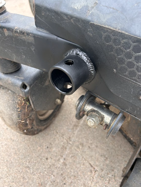 New pivot sleeve welded into the bracket on a piece of machinery, bead left as welded.